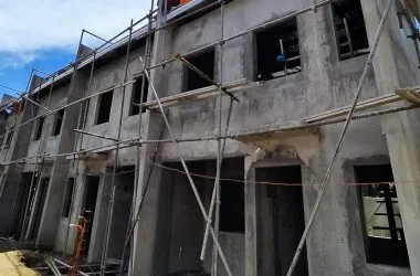 Construction progress photo — scaffolded two-storey row