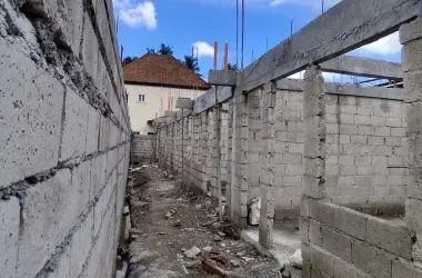 Construction progress photo — hollow-block walls between units